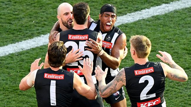 MELBOURNE, AUSTRALIA - SEPTEMBER 30: Steele Sidebottom of the Magpies is congratulated by team mates after kicking a goal during the 2023 AFL Grand Final match between the Collingwood Magpies and the Brisbane Lions at the Melbourne Cricket Ground on September 30, 2023 in Melbourne, Australia. (Photo by Josh Chadwick/AFL Photos via Getty Images)