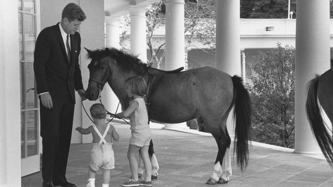 American President John F. Kennedy and his children, John and Caroline, play with pony Macaroni, outside the White House's Oval Office, Washington DC, June 22, 1962. Picture: Photoquest/Getty Images