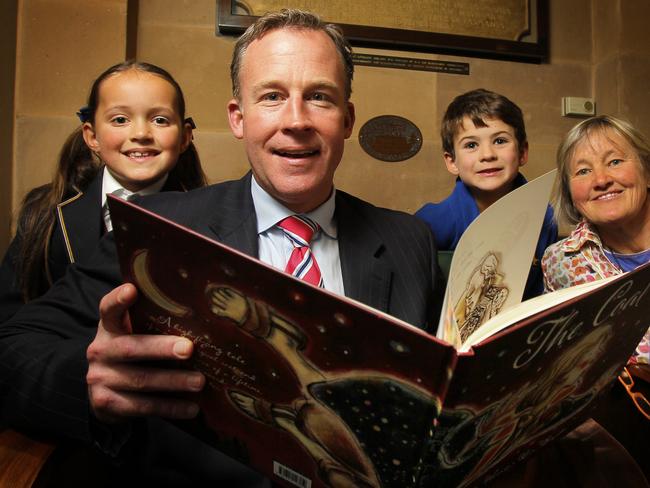 Premier of Tasmania Will Hodgman (centre) reads The Coat by Julie Hunt (right) and Ron Brooks to, Natasha Furjanic, 7, Fergus Depaoli, 8. The Premier will today launch the annual Premier’s Reading Challenge at Parliament House