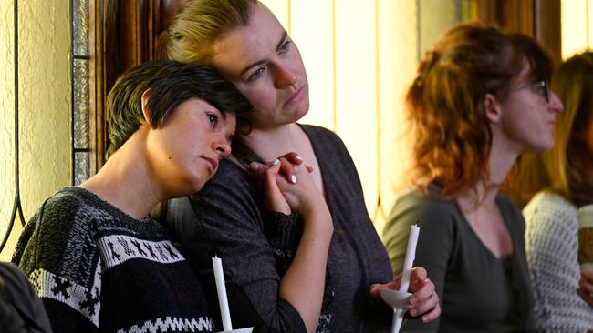 Sophia Diana, left, holds her friends hand, Lex Chapman, during a vigil at All Souls Unitarian Church for the victims of an overnight shooting at Club Q. Picture: Getty Images