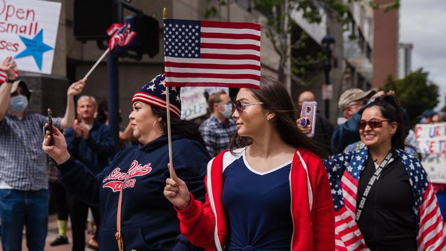 Protesters walk the American flag during the San Diego protest. Picture: AFP