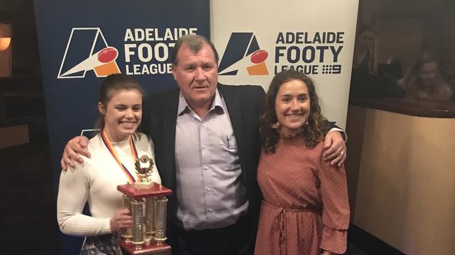 Adelaide University's Stephanie Walker after winning the 2019 Adelaide Footy League Women's division one best and fairest, with coach Mark Moody and teammate Matilda Zander who came runner-up in the medal count. Picture: Supplied