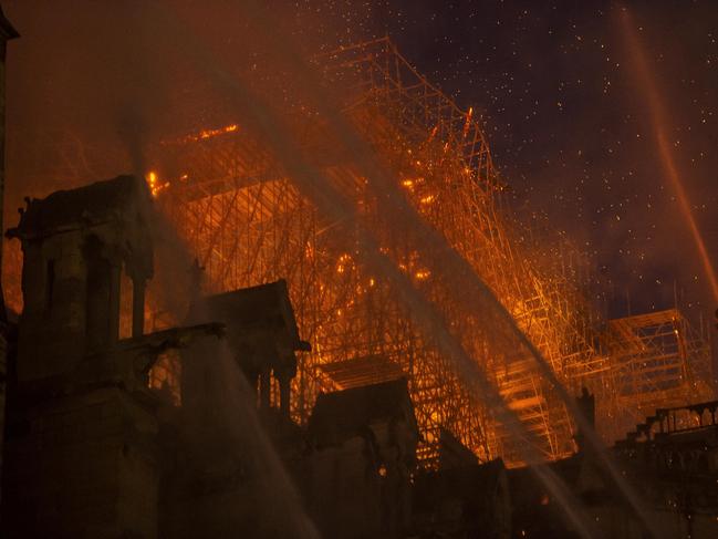 Smoke and flames rise during a fire at the landmark Notre-Dame Cathedral in central Paris on April 15, 2019, potentially involving renovation works being carried out at the site, the fire service said. Photo by Eliot Blondet /ABACAPRESS.COM/AAP