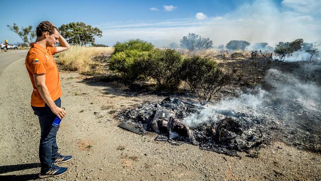 Vattenfall solar team driver looks at the remains of the car. Picture: Hans-Peter van Velthoven / Vattenfall Solar Team