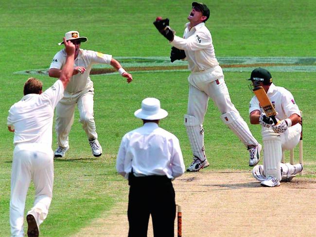 Adam Gilchrist takes a catch off the bowling of Shane Warne to dismiss South Africa’s Jacques Kallis at the SCG in 2002. Picture: Brett Costello