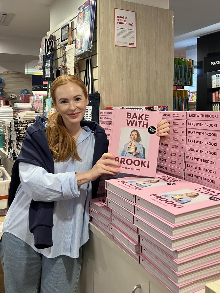 Brooke Bellamy holding her latest book which has been called out by her cooking rival. Picture: Supplied.