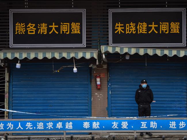 A security guard stands outside the Huanan Seafood Wholesale Market where the coronavirus was detected in Wuhan. Picture: AFP