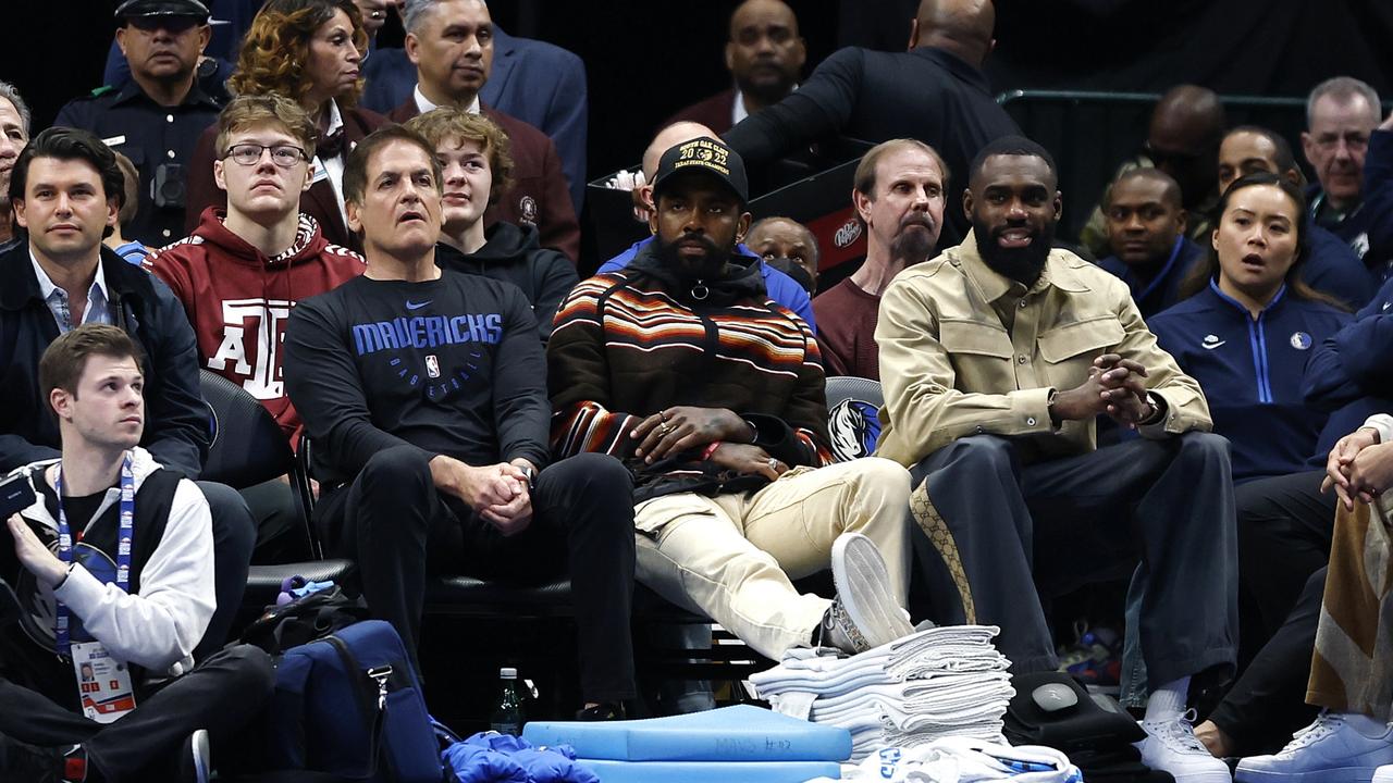 (L to R) Dallas Mavericks owner Mark Cuban, Kyrie Irving and Tim Hardaway Jr. sit court side during the game against the Chicago Bulls. Picture: Getty Images