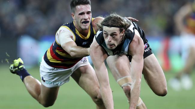 Lachie Murphy heaps the pressure on Port’s Jarrod Lienert Picture SARAH REED