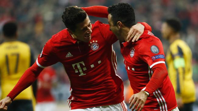 Bayern Munich's Spanish midfielder Thiago Alcantara (R) celebrate scoring the 3-1 goal with Bayern Munich's Polish forward Robert Lewandowski.