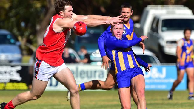 Somerville recruit Tim McGenniss gets a kick away under pressure against Red Hill. Picture: Derrick den Hollander