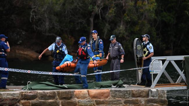 The body of a passenger aboard a seaplane is brought ashore.