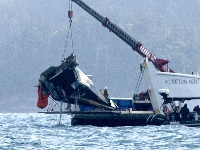 #NO AUSTRALIAN, NO NEWSWIRE NO ONSALE # A barge anchored at the site where a MRH 90 Taipan military helicopter crashed, lifts out the tail section. in the Whitsundays while carrying four Australians -Saturday 29 July 2023 Picture: Michaela Harlow