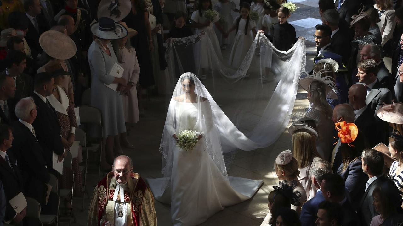 Meghan Markle walking down the aisle at her and Harry’s wedding in May 2018. Picture: AP.