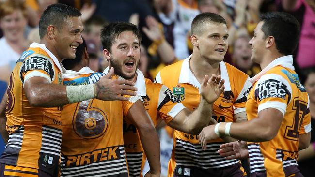 Anthony Milford is swamped by team mates after his try. Brisbane Broncos play the Parramatta Eels at Suncorp Stadium. Pic Jono Searle.