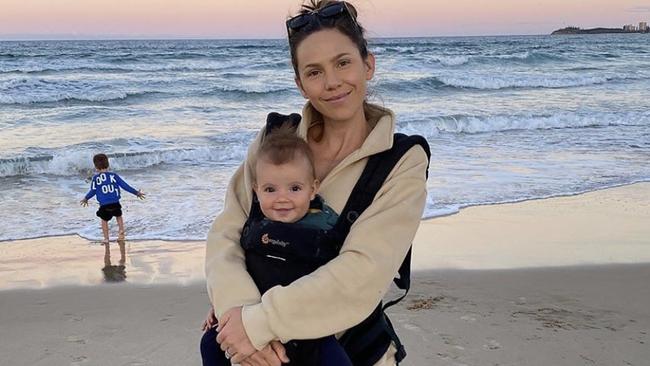 Alex Pendlebury with baby Darcy on the beach in Queensland.