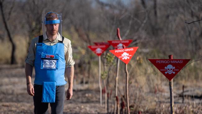 Prince Harry walks through a mine field in Dirico, Angola, during a visit to see the work of landmine clearance charity the Halo Trust on day five of the royal tour of Africa. Picture: Getty