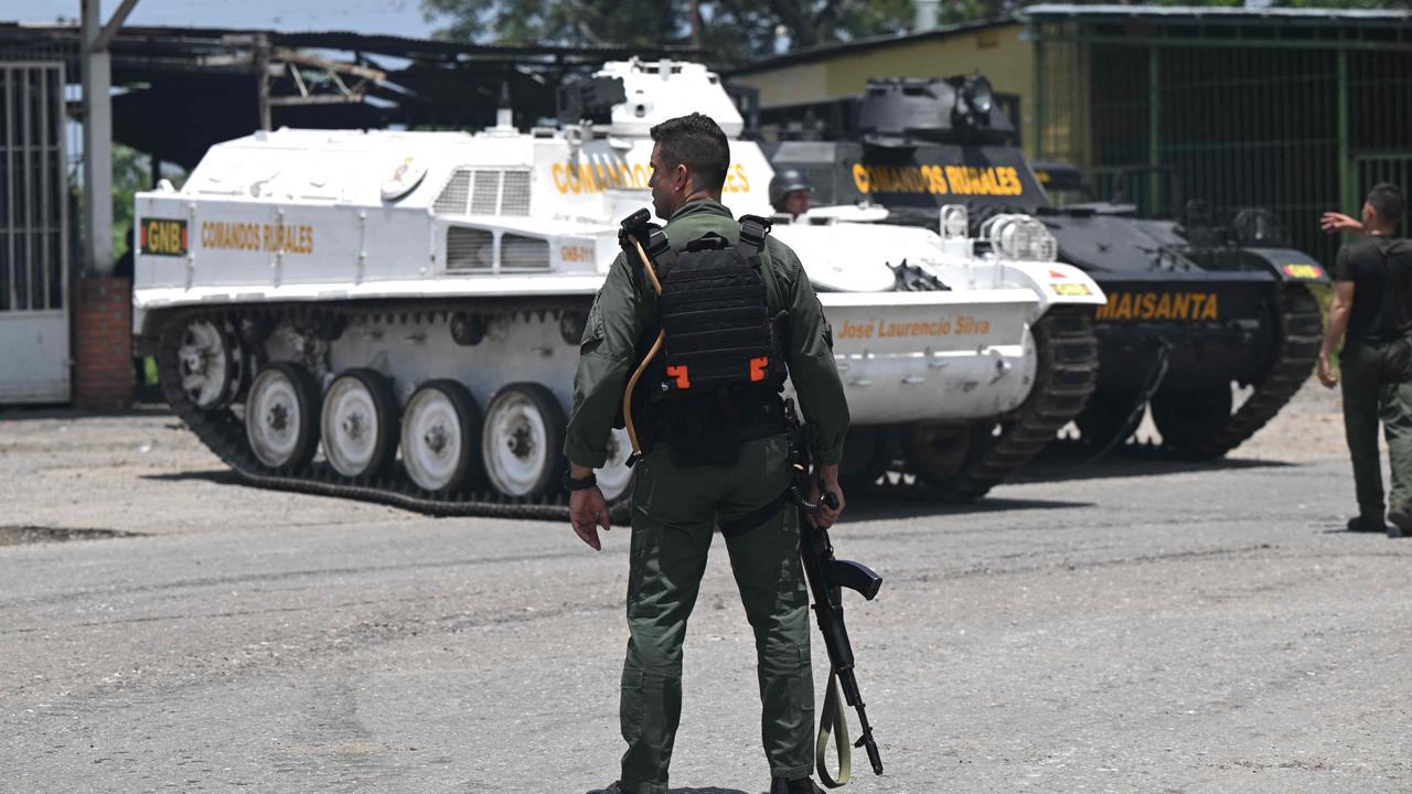 Armored vehicles are seen near the Tocoron prison after authorities seized control of it. Picture: Yuri Cortez/AFP