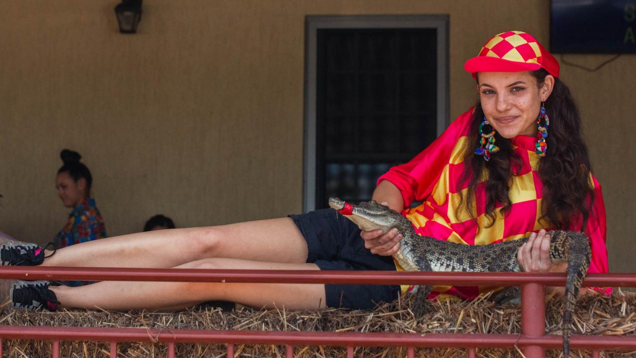 Croc racing at the Berry Springs Tavern for Melbourne Cup Day: Bartender and ‘jockey’ Gypsy Cass with one of the competing crocs. Picture: GLENN CAMPBELL