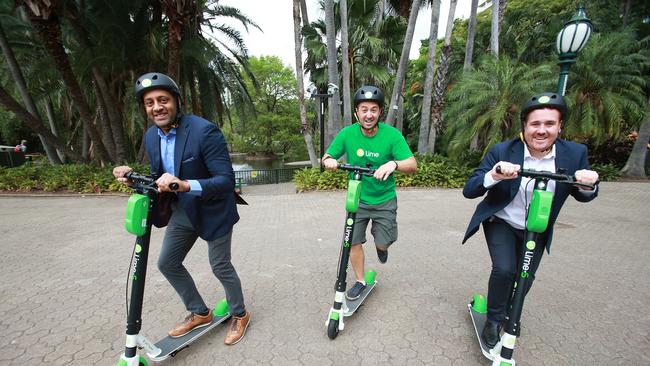 Members of the Lime team trying out the bikes in Brisbane. (AAP Image/Claudia Baxter)