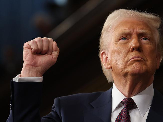 US President Donald Trump raises his fist as he addresses a joint session of Congress at the US Capitol in Washington, DC, on March 4, 2025. (Photo by Win McNamee / POOL / AFP)