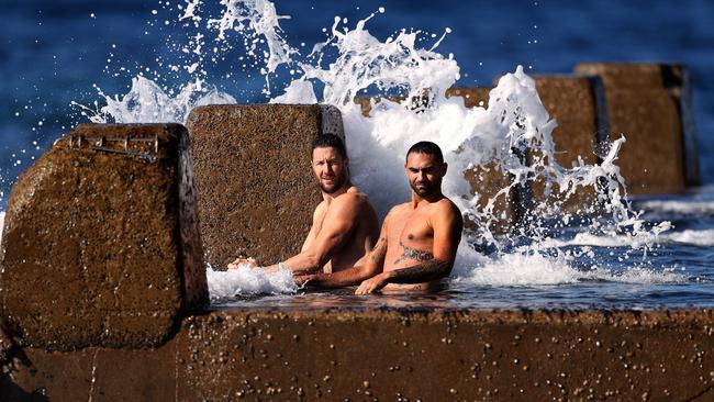 Hawthorn players James Frawley and Shaun Burgoyne take a dip in the ocean pool at Coogee Beach on Monday after the club escaped Melbourne before the NSW border closed. Picture. Phil Hillyard