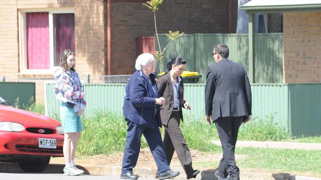 A friend arrives and talks to police at Ms Hanley’s house.