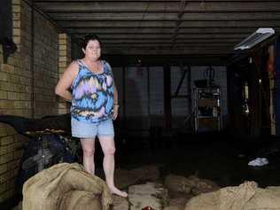 Linda Burley of Kent St, Grafton in her inundated garage.