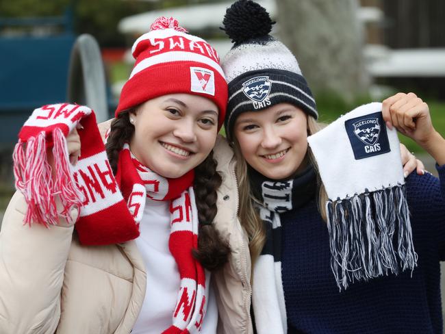 Footy fans Georgia Arthana and Natalie Henley-Smith waiting to see the AFL Grand Final parade on the Yarra River. Picture: David Crosling