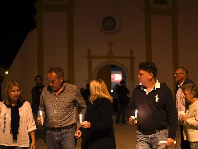 Church goers hold candles as they leave the church in Praia da Luz, near Lagos after a mass marking the 10th anniversary of Madeleine McCann’s disappearance. Picture: AFP