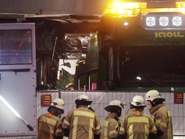 A truck, which ran into a crowded Christmas market killing several people is taken away by another truck in Berlin, Germany. Picture: AP