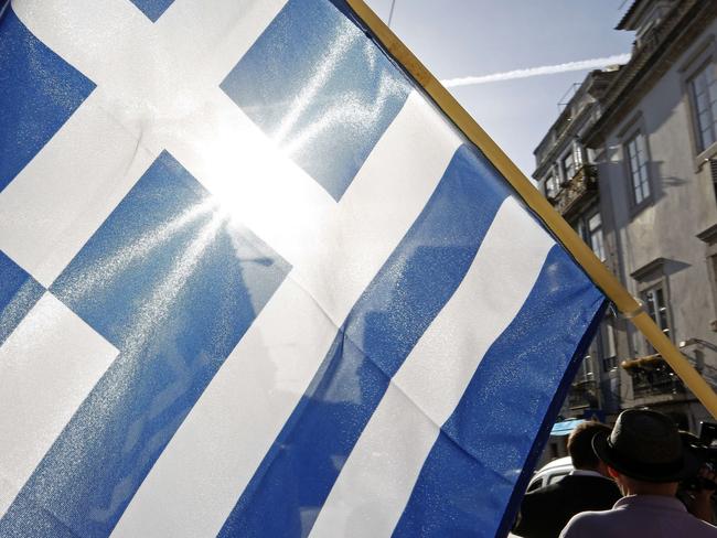 A national Greek flag is seen during a demonstration on July 4, 2015 a day before nearly 10 million Greek voters take to the ballot booths. Picture: JOSE MANUEL RIBEIRO