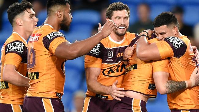 Darius Boyd of the Broncos celebrates scoring a try with team mates