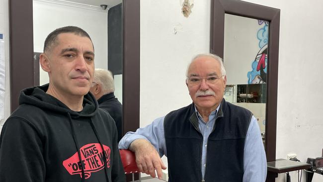 Barber Mario Mercurio with his son John during the final days of work. Picture: Ashleigh Tullis