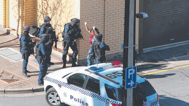 The second of four women held during yesterday’s seige is released. Picture: Tait Schmaal.