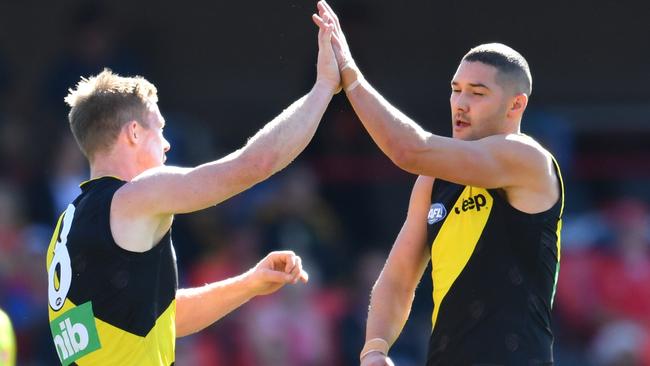 Jack Riewoldt and Shaun Grigg celebrate a goal against the Suns.