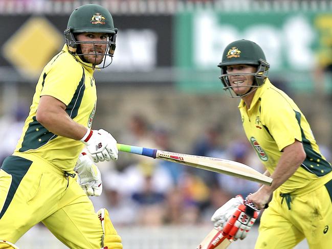 Australian batsman David Warner, right, and Aaron Finch run between the wickets during their One Day International cricket match against India in Canberra, Australia, Wednesday, Jan. 20, 2016. (AP Photo/Rob Griffith)