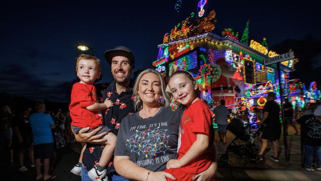 David and Chloe Strickland with their children Noah and Piper at their Burpengary East home covered in Christmas lights. Picture Lachie Millard