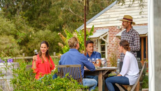 Murray Gomm, standing, with visitors at Oranje Tractor Wines.