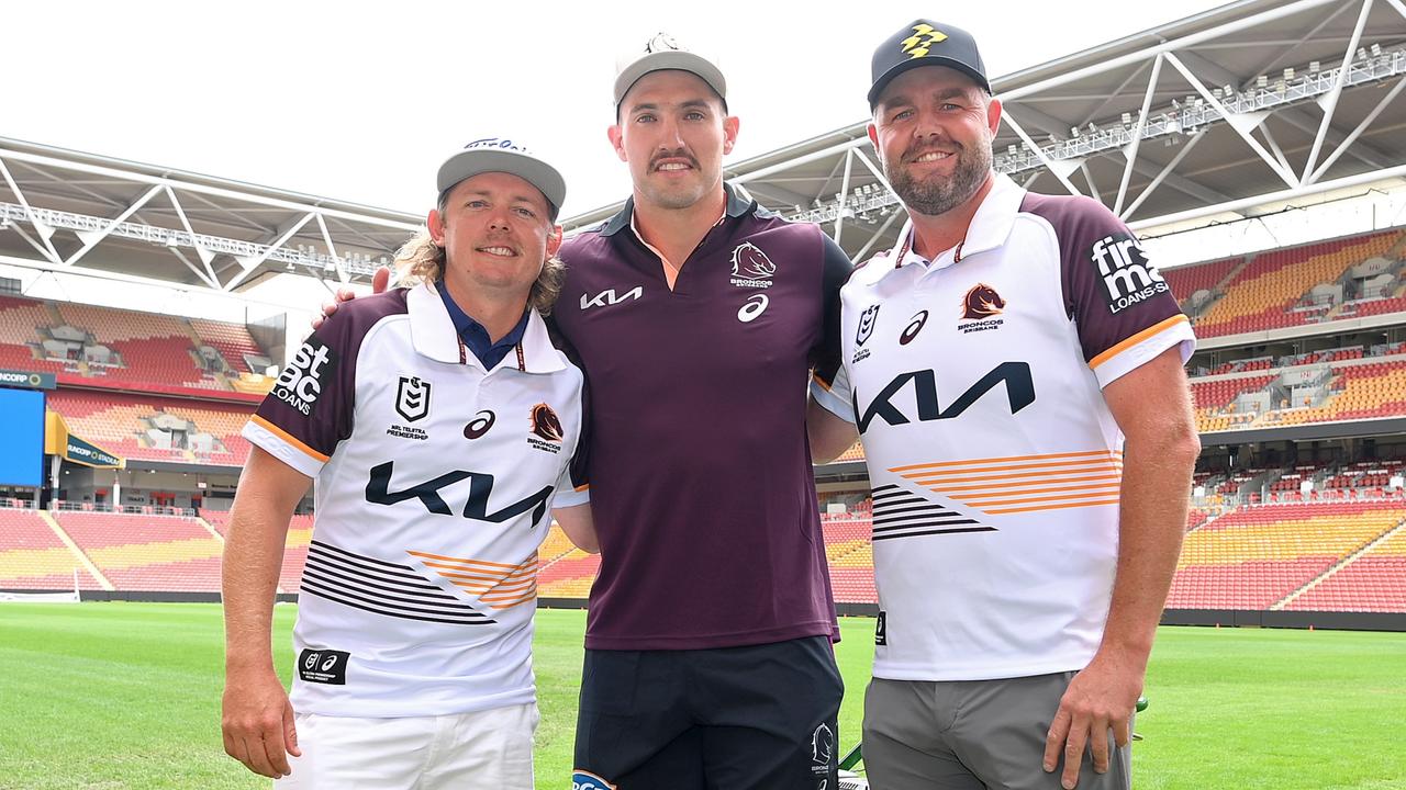 Golfers Cameron Smith (left) and Marc Leishman (right) meet Brisbane Broncos NRL player Corey Oates (middle) at Suncorp Stadium. Picture: Getty