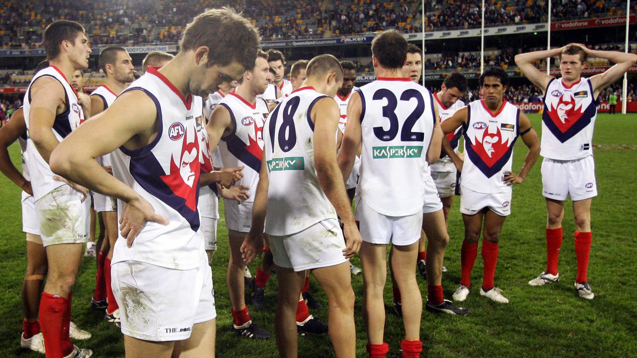 The Demons players show their disappointment after loss.