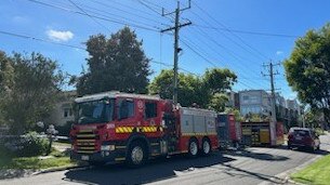 Firefighters remain at the scene on Wednesday to assess the home.