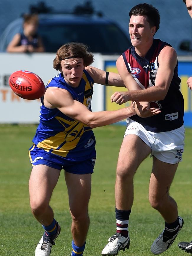 Charlie Constable shoots out a handball.