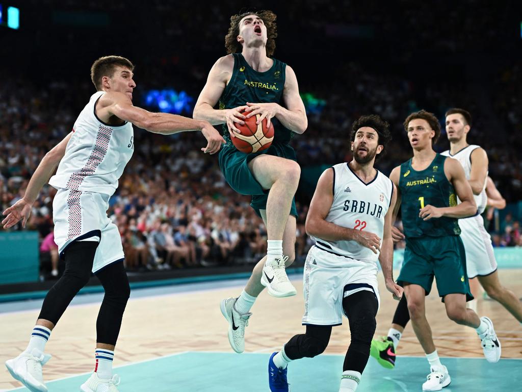 Australia's #03 Josh Giddey, centre, jumps with the ball in the men's quarterfinal basketball match between Serbia and Australia. Picture: Aris Messinis/AFP