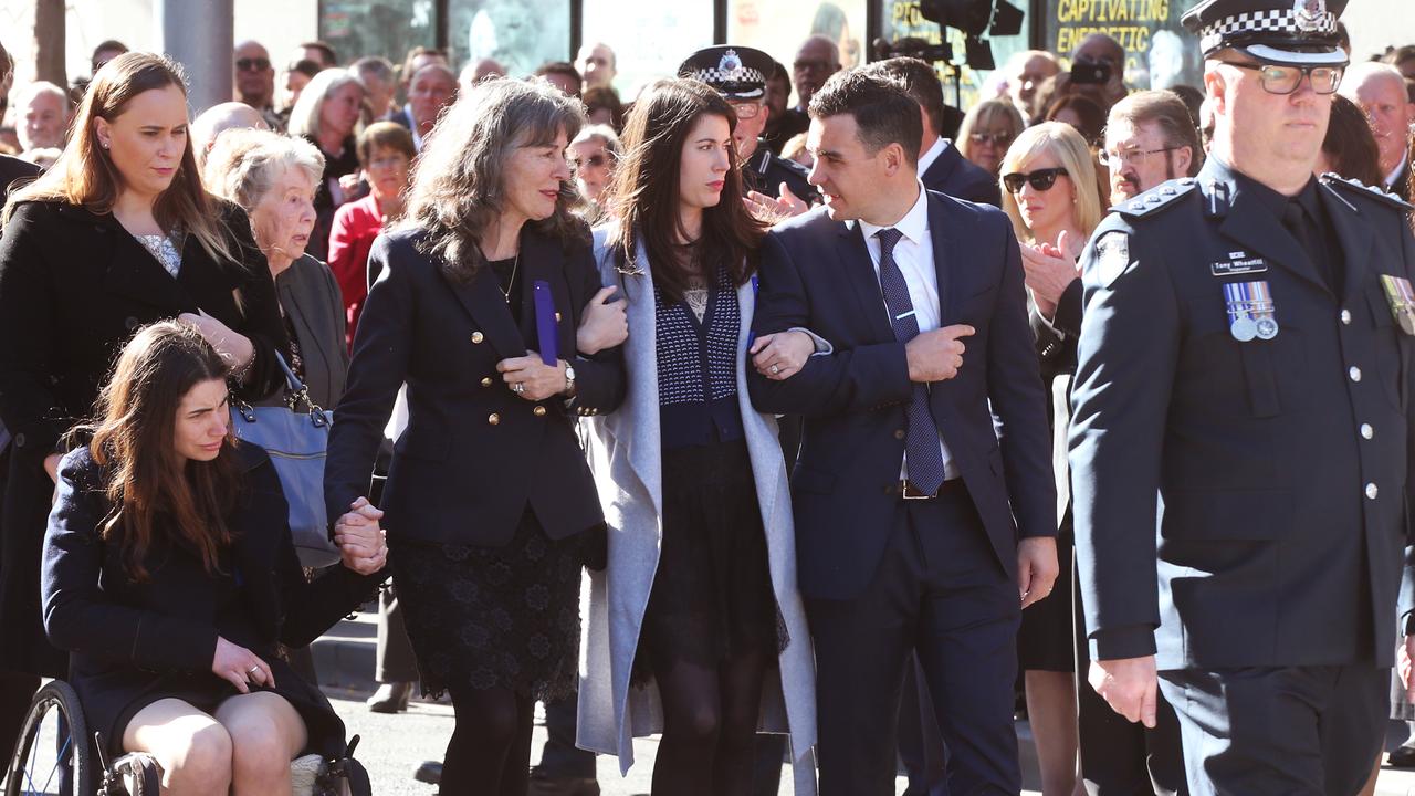 Katie, Chrissie, Aimee, and Chrissie’s son-in-law Luke follow the hearse at the State Funeral service for Anthony Foster on June 7, 2017. Picture: AAP Image/David Crosling.