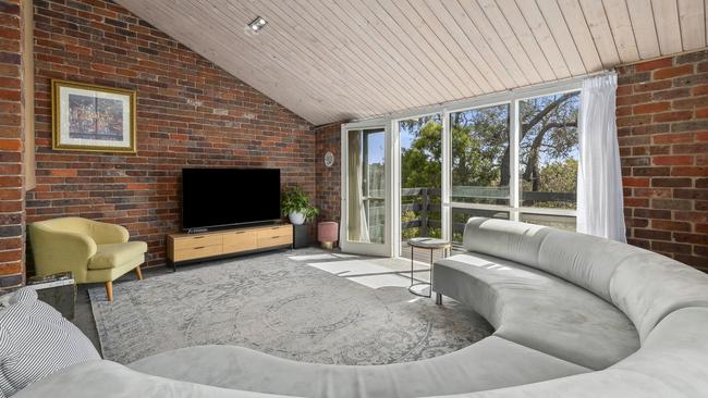 The living area has treetop views over the Queens Park precinct.