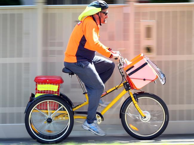 Postie Brendan Peel delivers mail with the new electric-assisted tricycle.