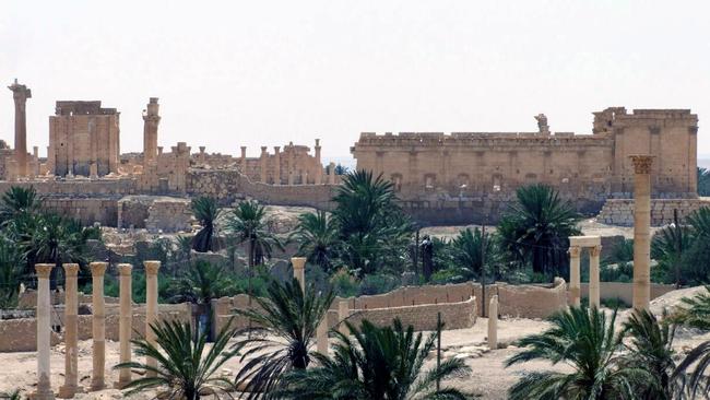 Ancient buildings dominate the desert landscape.