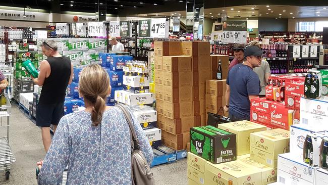 People shopping at Dan Murphy's bottle shop at Manly Vale in March. Now customers can order online and be in and out of the shop’s car park in less than three minutes. File picture: Damian Shaw