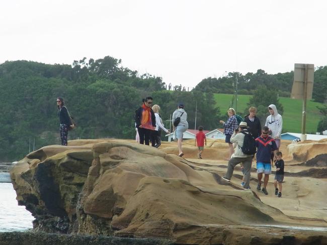 Large numbers of people on Terrigal headland.